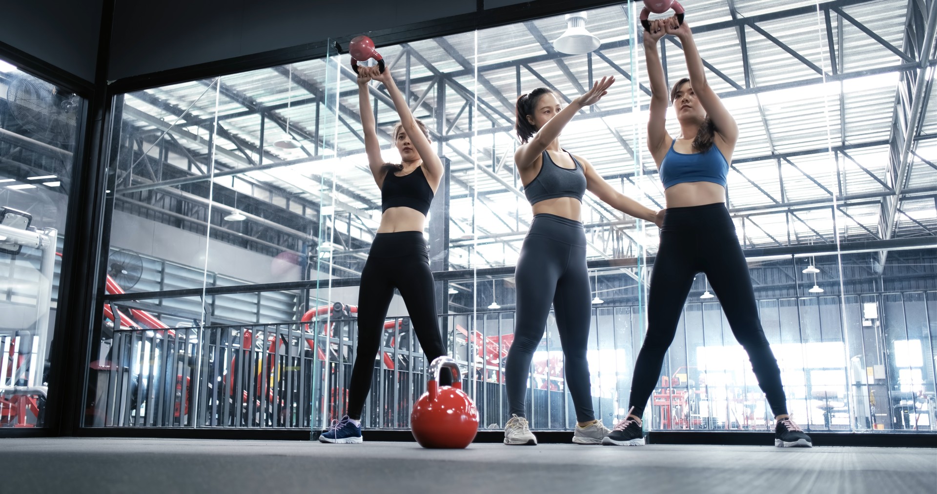 Group asian women training exercise workout at fitness gym in sportswear with personal trainer coaching use kettlebells, Sportive healthy bodybuilding, Athlete builder muscles lifestyle concept.